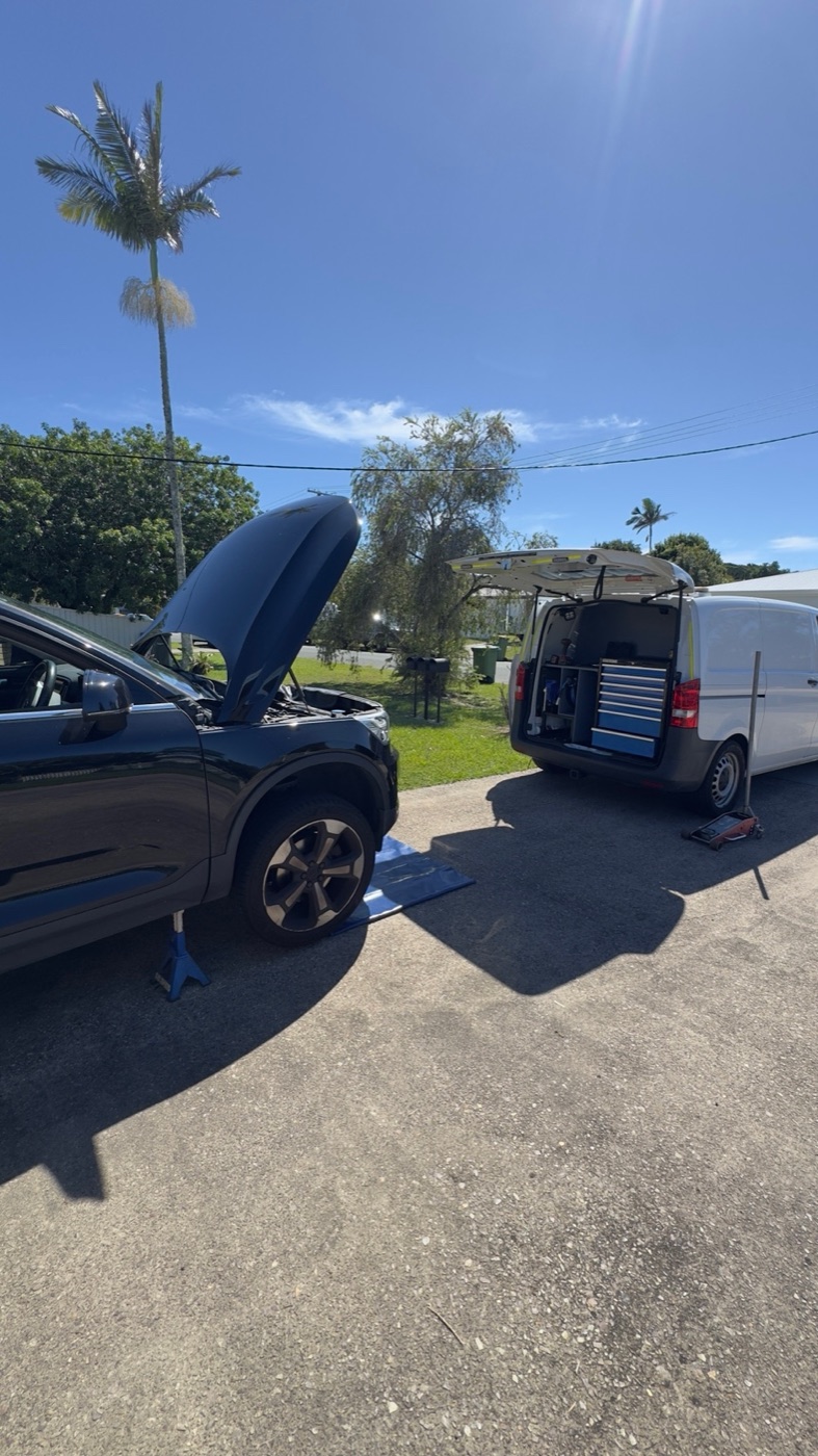 Mobile mechanic service van working on a vehicle at a Sunshine Coast home